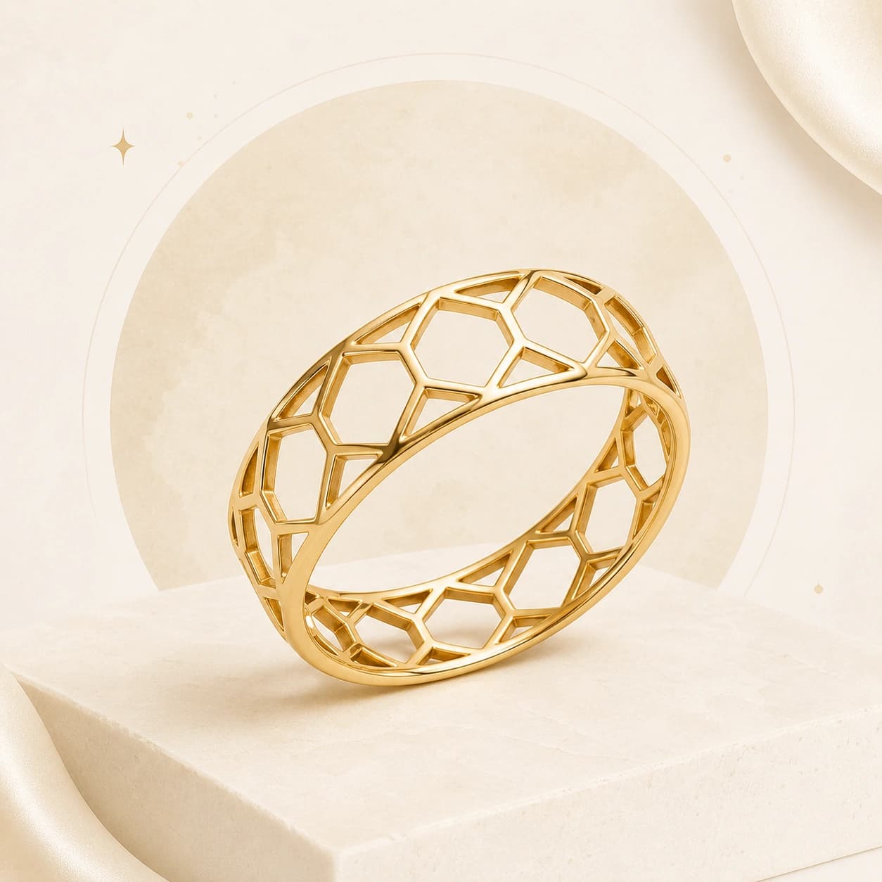 A yellow-gold geometric lattice ring on an ivory plinth