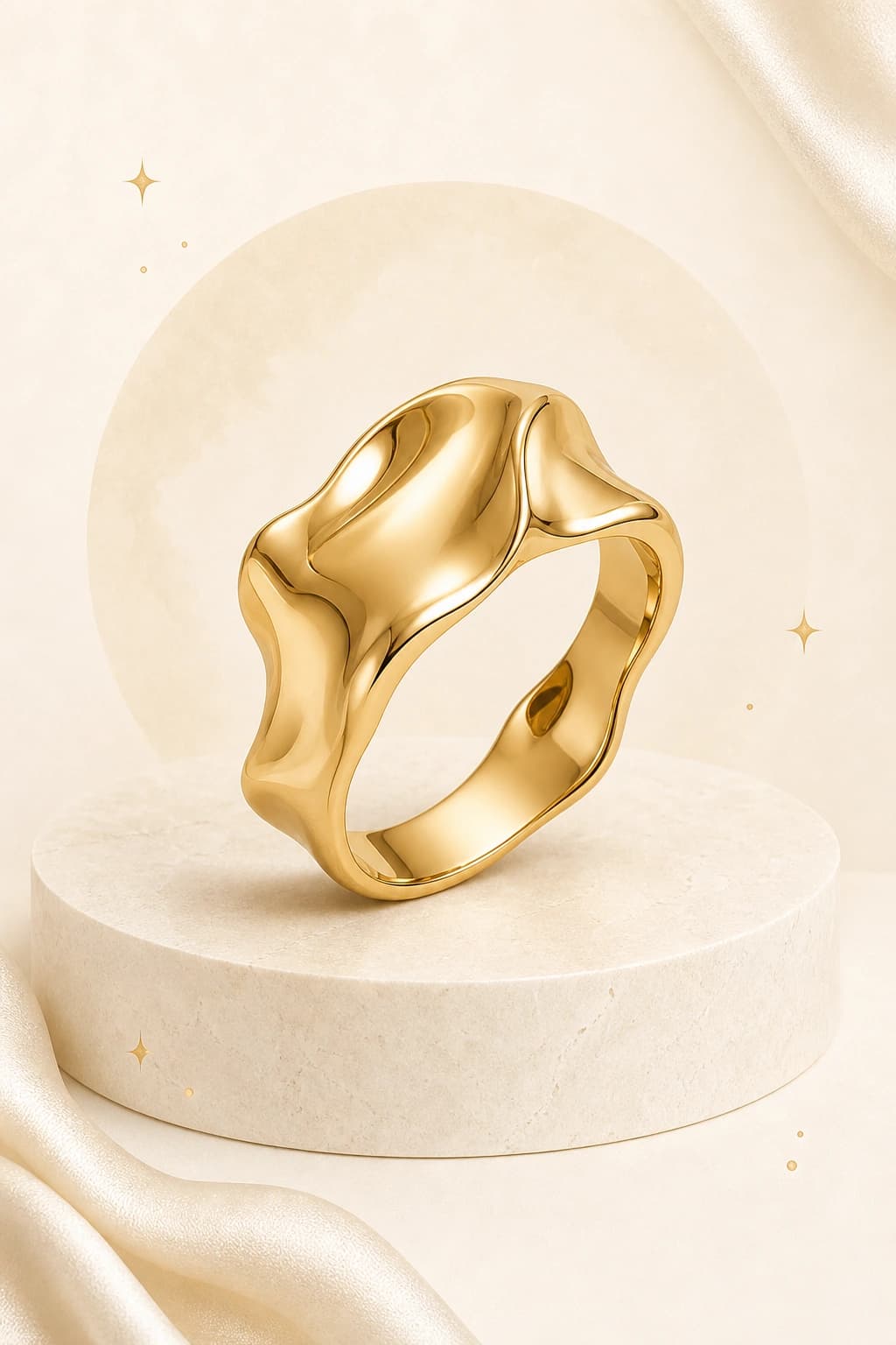 A sculptural yellow-gold ring on a pale stone pedestal
